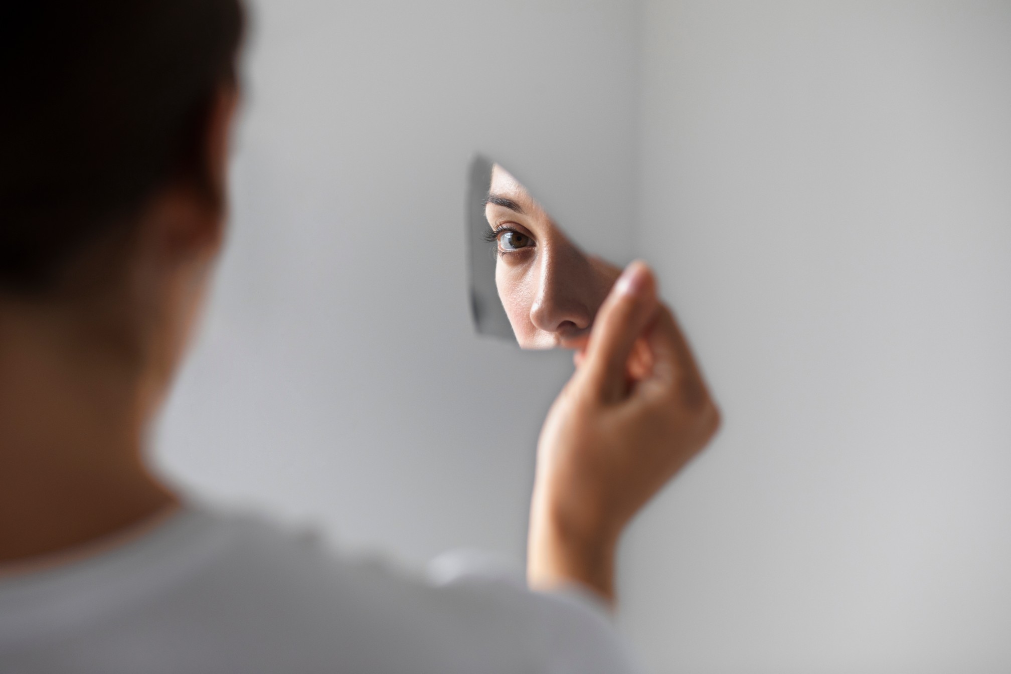 a-photo-of-a-woman-looking-into-a-mirror-exploring-the-essence-of-spirituality