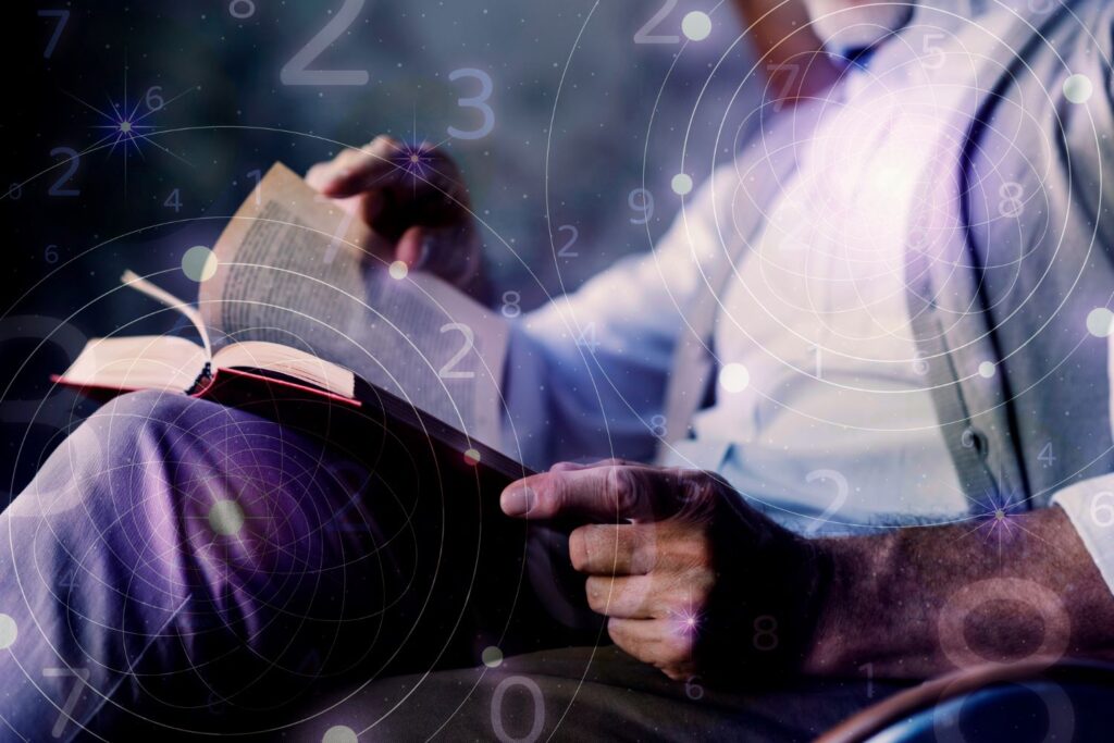 A man reading the Bible as he thinks of numbers.