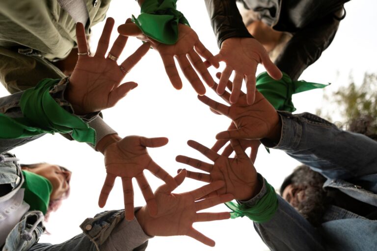 Bottom view of volunteers’ hands while doing affordable ways to give back