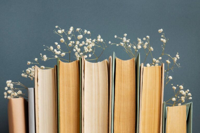 A collection of underrated coming-of-age memoirs, adorned with vibrant flowers on top.